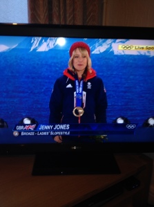 Jenny Jones receives her bronze at the Sochi medal ceremony